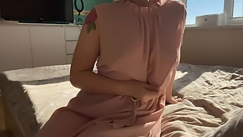 A Woman In A Delicate Pink Dress Explores Her Own Sensuality